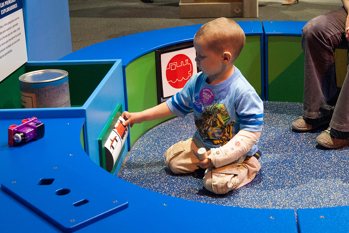 toddler playing with a train spinner